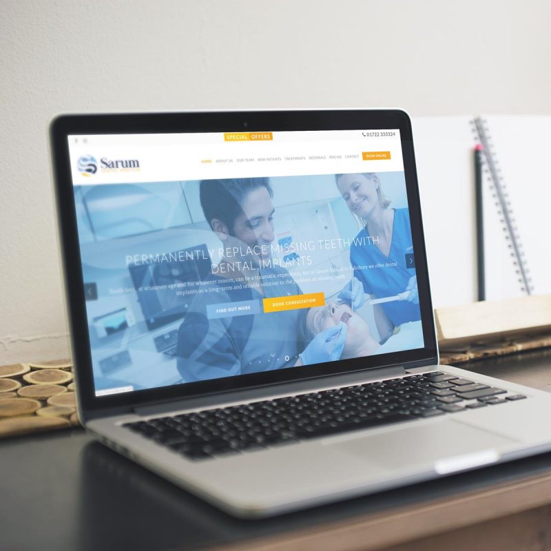 image of laptop with sarum dental website on the screen